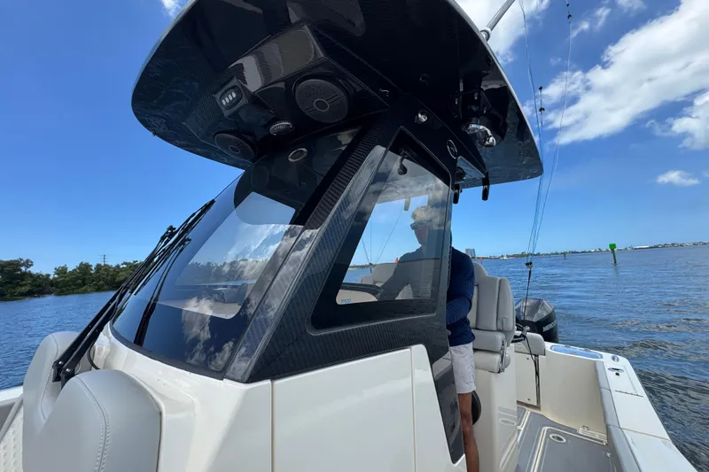 Slide: The Image of 2026 Scout 260 LXF boat on water, featuring sleek design and modern console. - 14