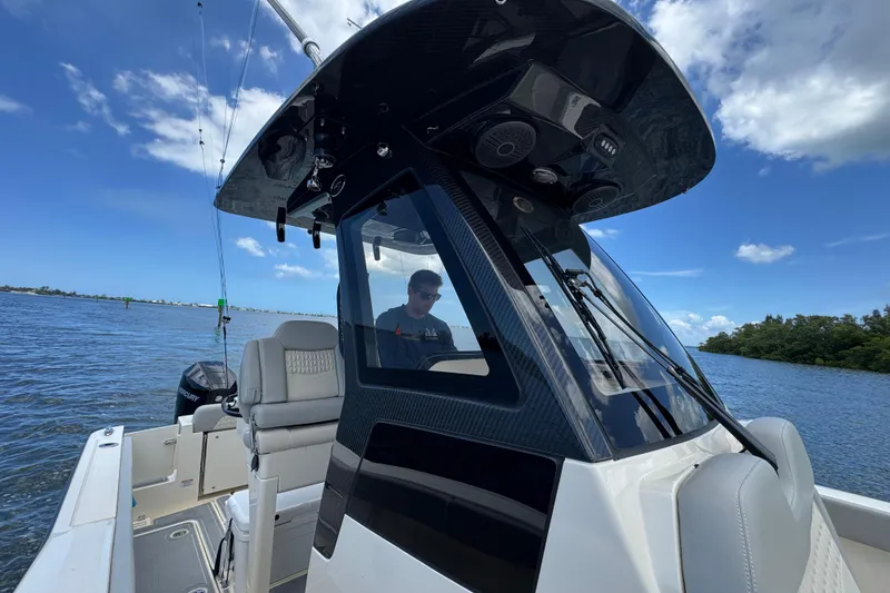 Slide: The Image of 2026 Scout 260 LXF boat cruising on a sunny day with clear blue skies. - 15
