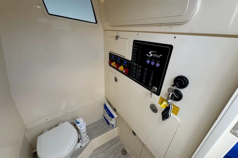 Slide: The Image of Interior of 2026 Scout 260 LXF boat featuring control panel and marine toilet. - 17