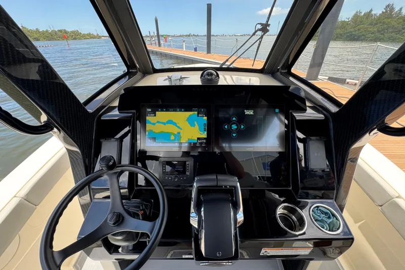 Slide: The Image of Helm of 2026 Scout 260 LXF boat with advanced navigation displays. - 18