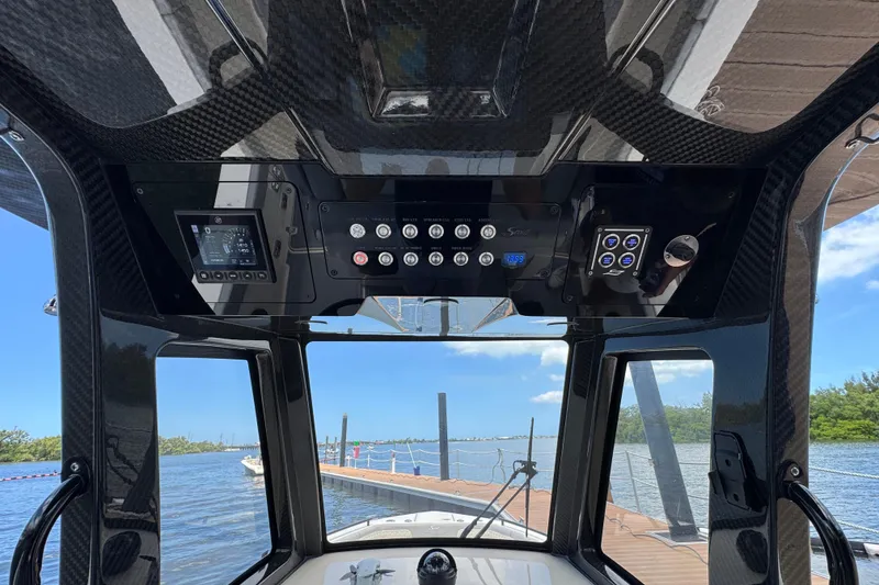 Slide: The Image of 2026 Scout 260 LXF boat dashboard with advanced controls and scenic water view. - 20