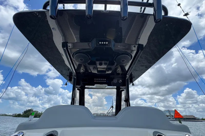 Slide: The Image of 2026 Scout 260 LXF boat with sleek design, viewed from below against a cloudy sky. - 21