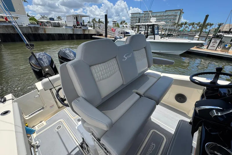 Slide: The Image of 2026 Scout 260 LXF boat interior with dual Mercury engines at marina. - 22