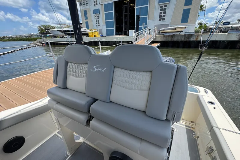 Slide: The Image of 2026 Scout 260 LXF boat seats with elegant design, docked near a marina. - 23