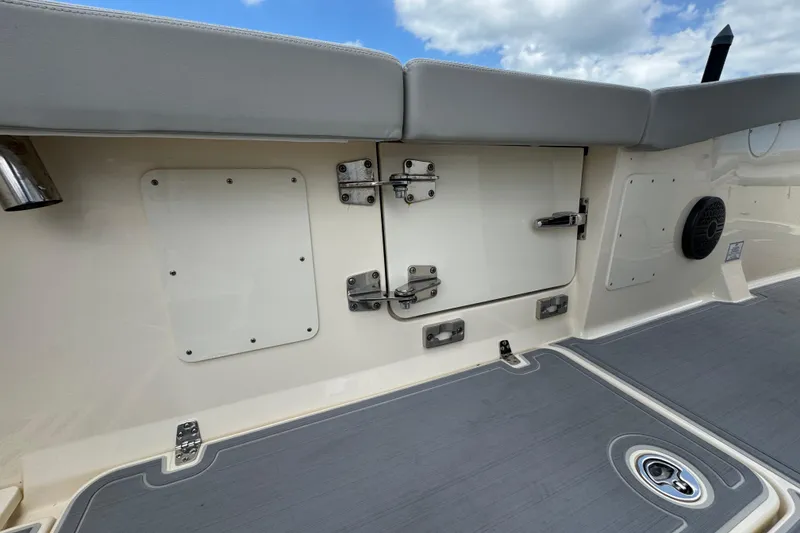 Slide: The Image of Interior view of 2026 Scout 260 LXF boat, featuring storage compartments and seating. - 25