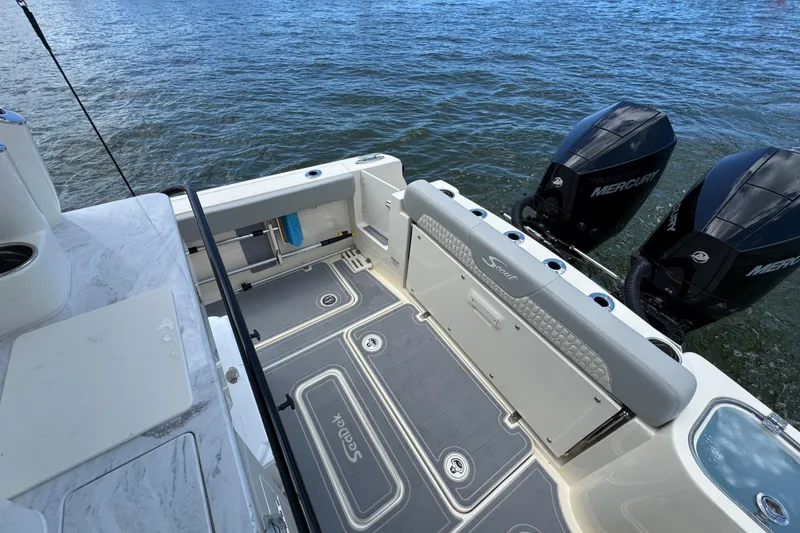 Slide: The Image of 2026 Scout 260 LXF boat deck with dual Mercury engines on water. - 31