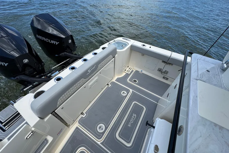 Slide: The Image of 2026 Scout 260 LXF boat deck with twin Mercury engines on water. - 32