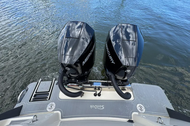 Slide: The Image of Twin Mercury engines on a 2026 Scout 260 LXF boat in water. - 34