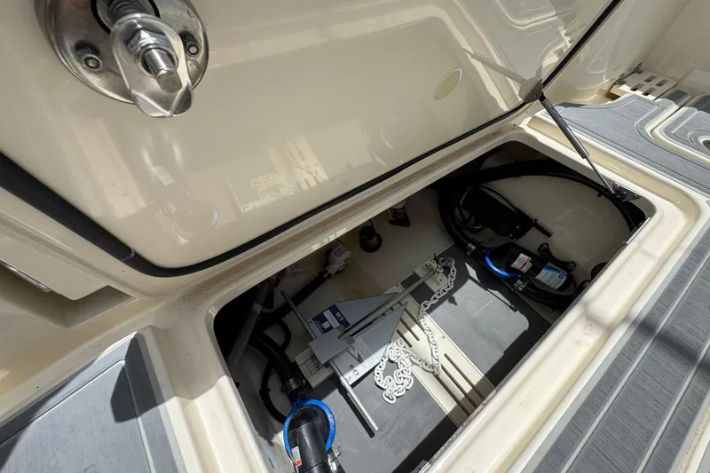 Slide: The Image of Open storage compartment of 2026 Scout 260 LXF boat, showing anchor and equipment. - 35