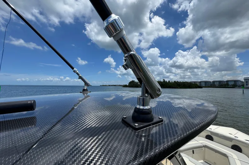 Slide: The Image of 2026 Scout 260 LXF boat with carbon fiber detail, ocean view, and blue sky. - 36