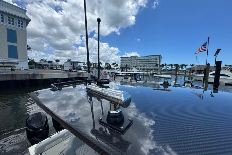 Slide: The Image of 2026 Scout 260 LXF boat docked at marina with American flag and blue sky. - 37