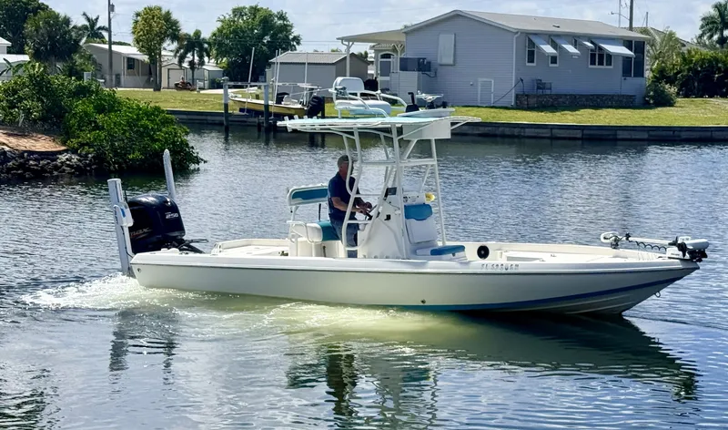 Slide: The Image of 2017 Skeeter SX230 boat anchored on calm water. - 2