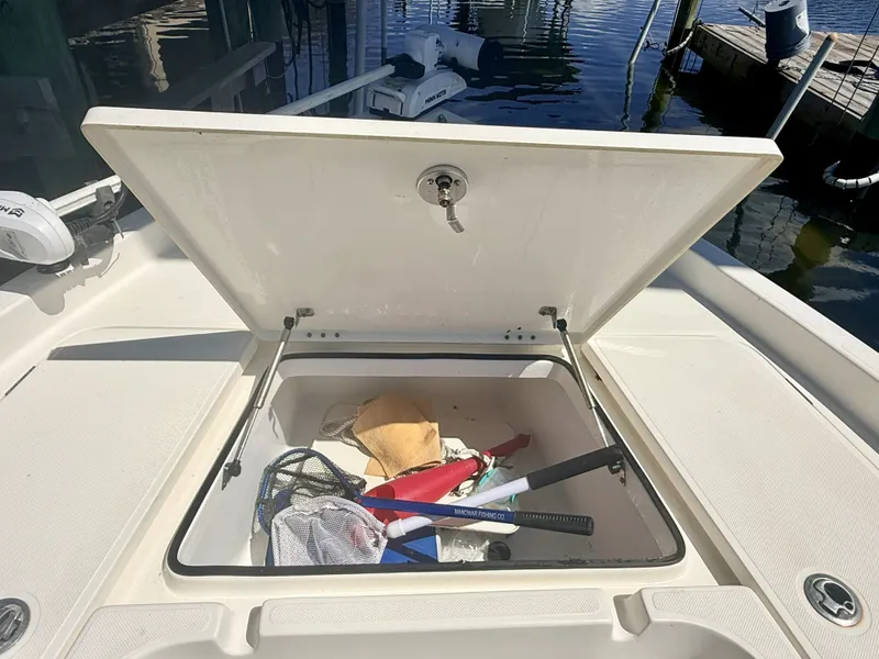 Slide: The Image of Open storage compartment on a 2017 Skeeter SX230 boat. - 8