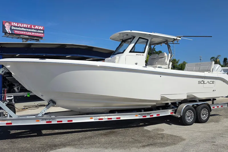 The Image of 2026 Solace 30CS boat on trailer under clear blue sky. - 1