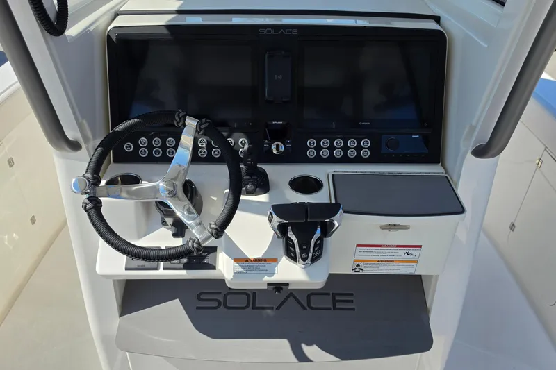 Slide: The Image of 2026 Solace 30CS boat dashboard with steering wheel and control panel. - 10