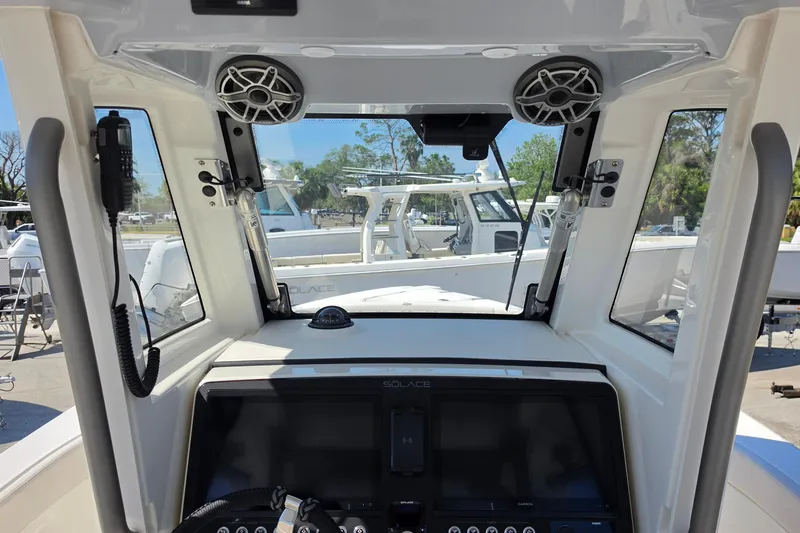 Slide: The Image of Interior view of 2026 Solace 30CS boat cockpit with modern controls and speakers. - 11