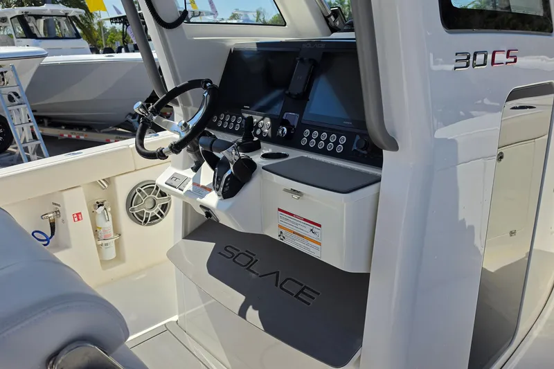 Slide: The Image of 2026 Solace 30CS boat cockpit with modern steering and control panel. - 13