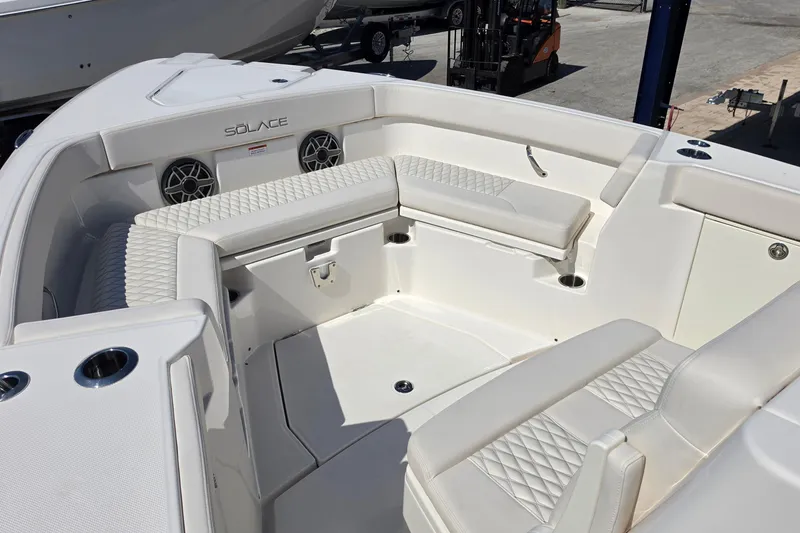 Slide: The Image of 2026 Solace 30CS boat interior with white seating and cup holders. - 15