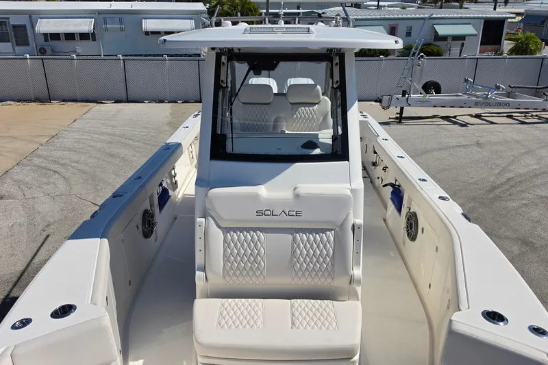 Slide: The Image of 2026 Solace 30CS boat with sleek design and modern seating, docked outdoors. - 20