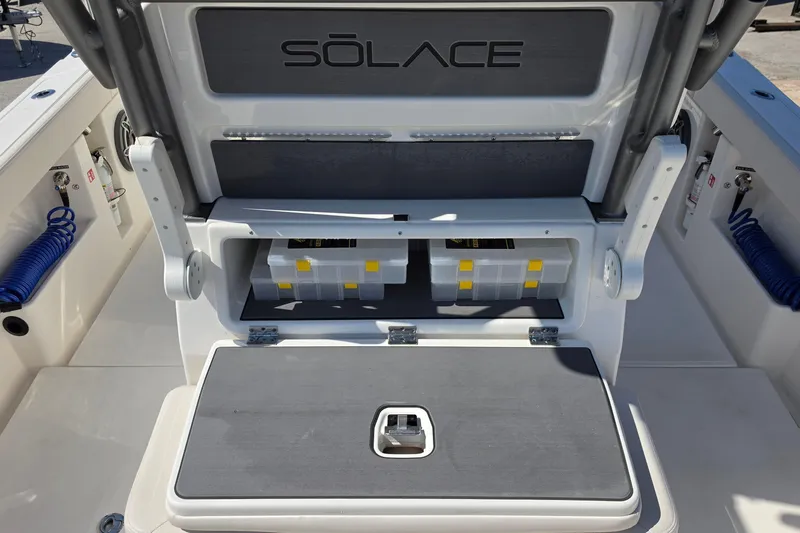 Slide: The Image of 2026 Solace 30CS boat storage compartment with organized tackle boxes and sleek design. - 27