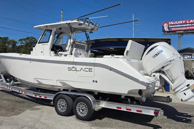 Slide: The Image of 2026 Solace 30CS boat on trailer with Yamaha engine, parked outdoors. - 3