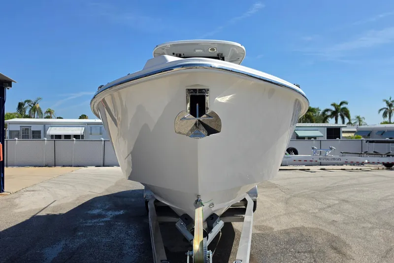 Slide: The Image of Front view of a 2026 Solace 30CS boat on a trailer under a clear blue sky. - 6