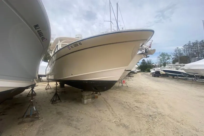 Slide: The Image of 2016 Grady-White Freedom 307 boat on stands in a marina storage area. - 2