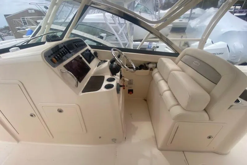 Slide: The Image of 2016 Grady-White Freedom 307 boat interior with steering console and seating. - 6