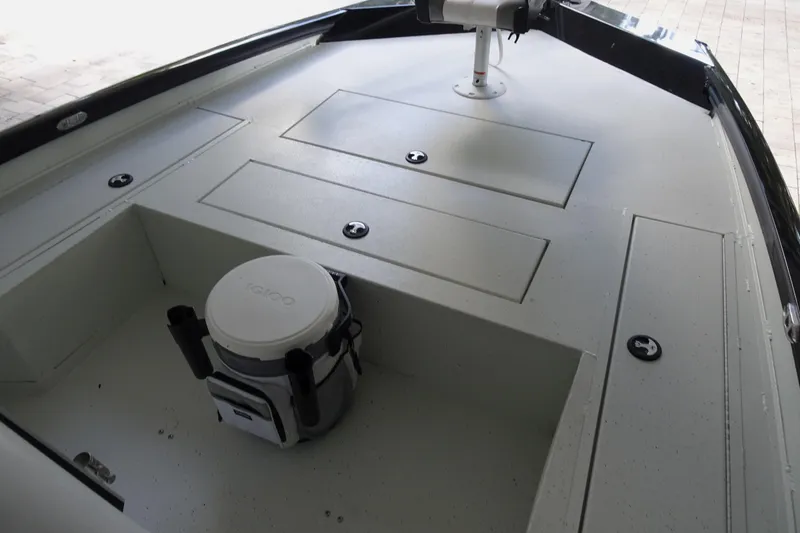 Slide: The Image of 2023 Crestliner 2000 Bay boat deck with storage compartments and cooler. - 10