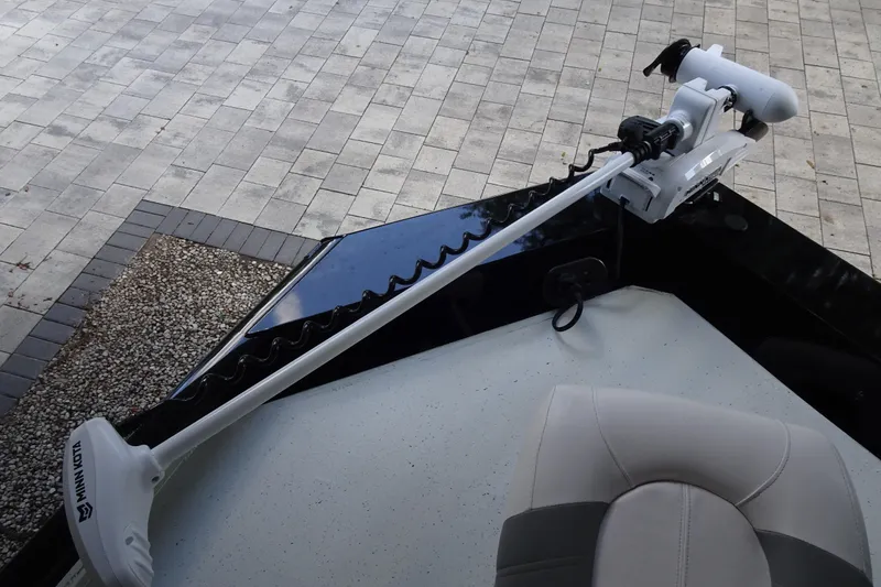 Slide: The Image of 2023 Crestliner 2000 Bay boat with Minn Kota trolling motor on paved surface. - 11
