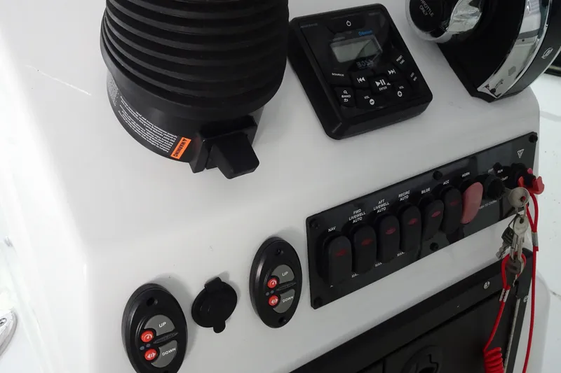 Slide: The Image of Control panel of 2023 Crestliner 2000 Bay boat with switches and keys. - 14