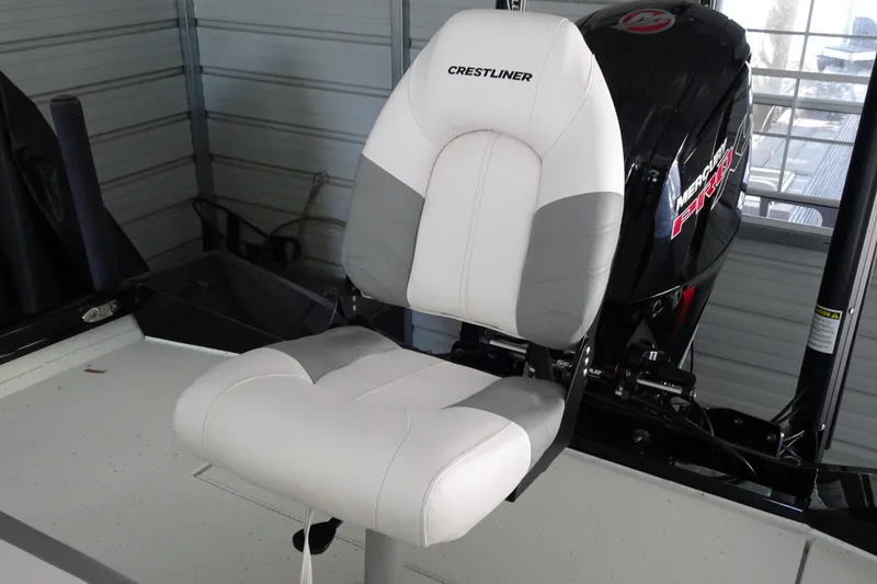 Slide: The Image of 2023 Crestliner 2000 Bay boat seat with Mercury engine in a garage setting. - 15