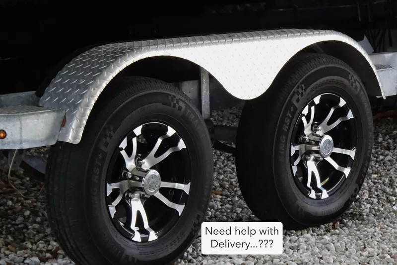 Slide: The Image of Trailer wheels of a 2023 Crestliner 2000 Bay boat on gravel surface. - 4