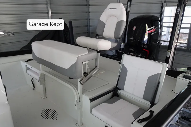 Slide: The Image of 2023 Crestliner 2000 Bay boat interior, garage kept, featuring seating and Mercury Pro motor. - 8