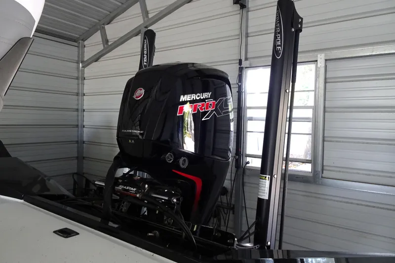 Slide: The Image of 2023 Crestliner 2000 Bay with Mercury Pro XS engine in a garage. - 9