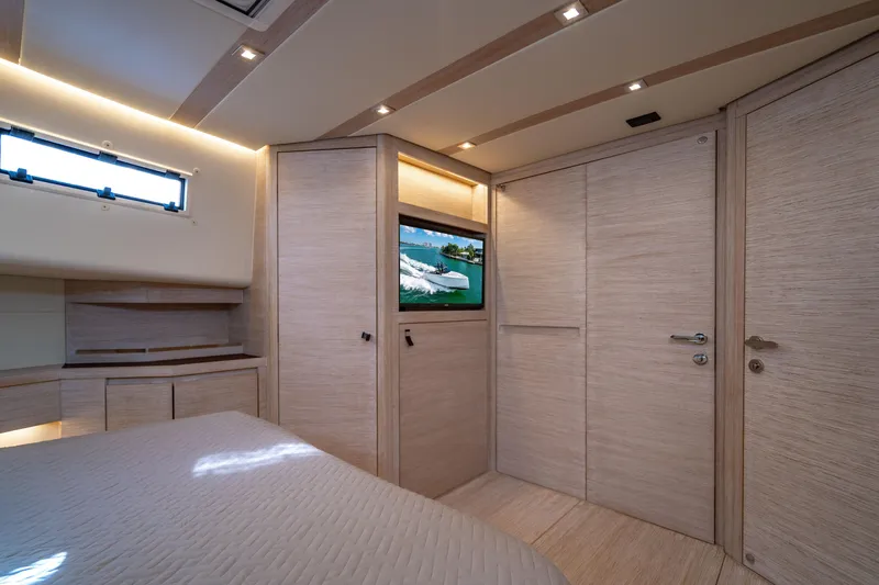 Slide: The Image of Luxurious interior of 2023 Pardo 50 yacht with modern wood finish and built-in TV. - 101