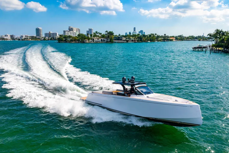 Slide: The Image of 2023 Pardo 50 yacht cruising on a sunny day with city skyline in the background. - 11