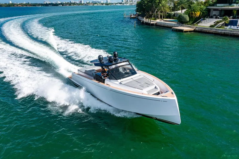 Slide: The Image of 2023 Pardo 50 yacht cruising on clear blue waters near a lush shoreline. - 17