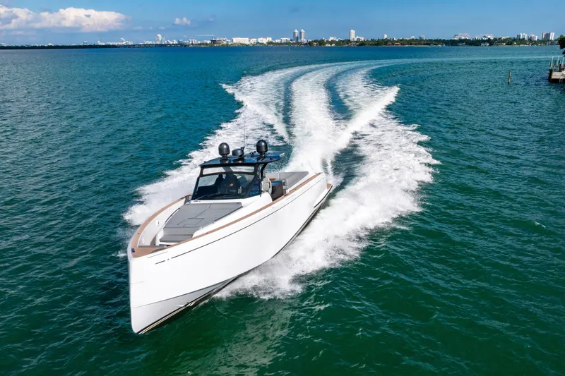 Slide: The Image of 2023 Pardo 50 yacht cruising on open water with city skyline in background. - 18