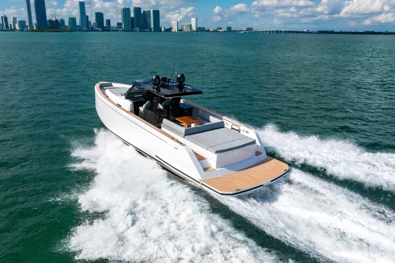 Slide: The Image of 2023 Pardo 50 yacht cruising on open water with city skyline in background. - 20