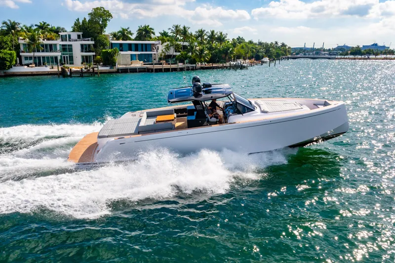 Slide: The Image of 2023 Pardo 50 yacht cruising on a sunny day near luxury waterfront homes. - 25