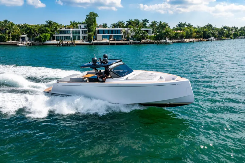 Slide: The Image of 2023 Pardo 50 yacht cruising on a sunny day near waterfront homes. - 26