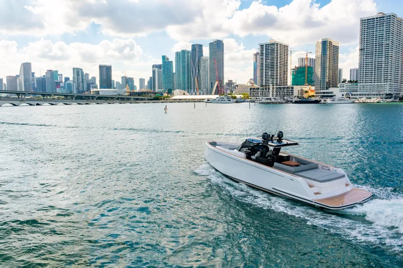 Slide: The Image of 2023 Pardo 50 yacht cruising near a city skyline under a partly cloudy sky. - 37