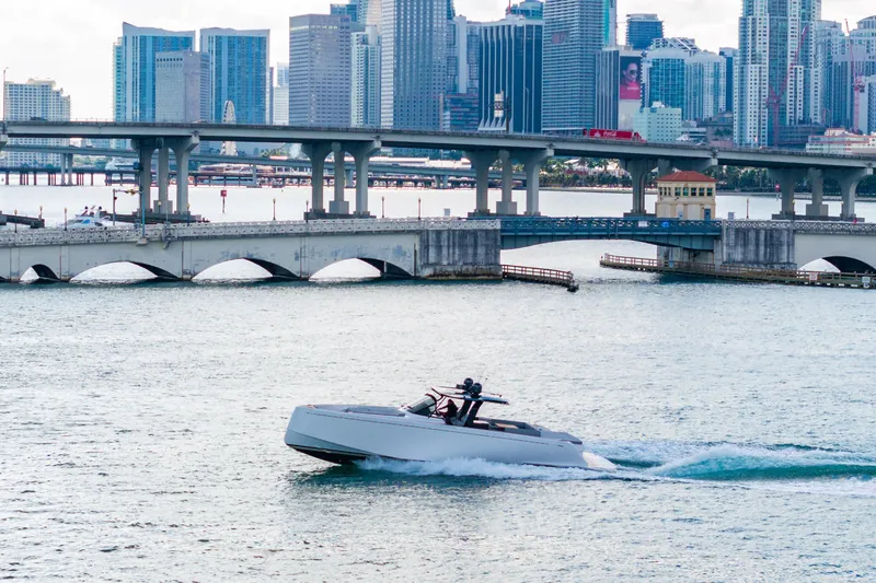 Slide: The Image of 2023 Pardo 50 yacht cruising near a city skyline and bridge. - 38