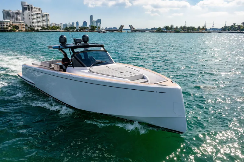 Slide: The Image of 2023 Pardo 50 yacht cruising in sunny coastal waters with city skyline backdrop. - 4
