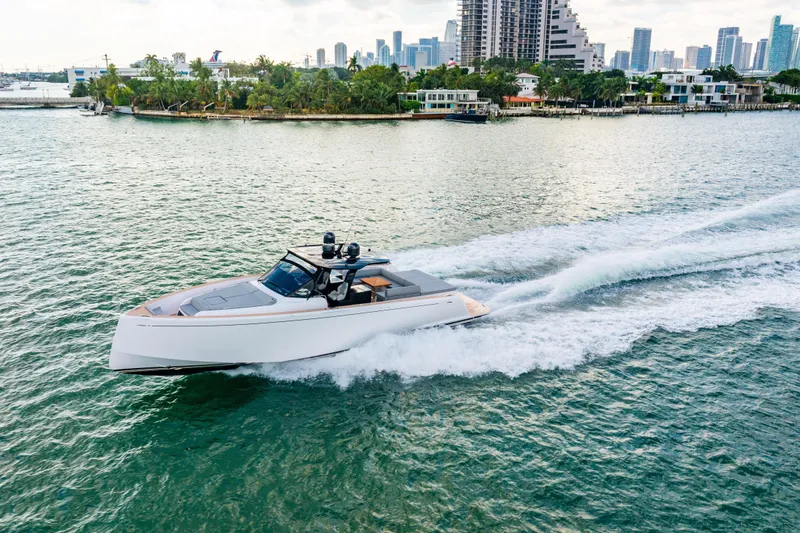 Slide: The Image of 2023 Pardo 50 yacht cruising near a city skyline and waterfront homes. - 41