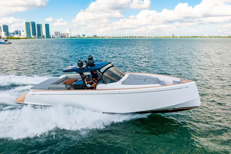 Slide: The Image of 2023 Pardo 50 yacht cruising on water with city skyline in background. - 42