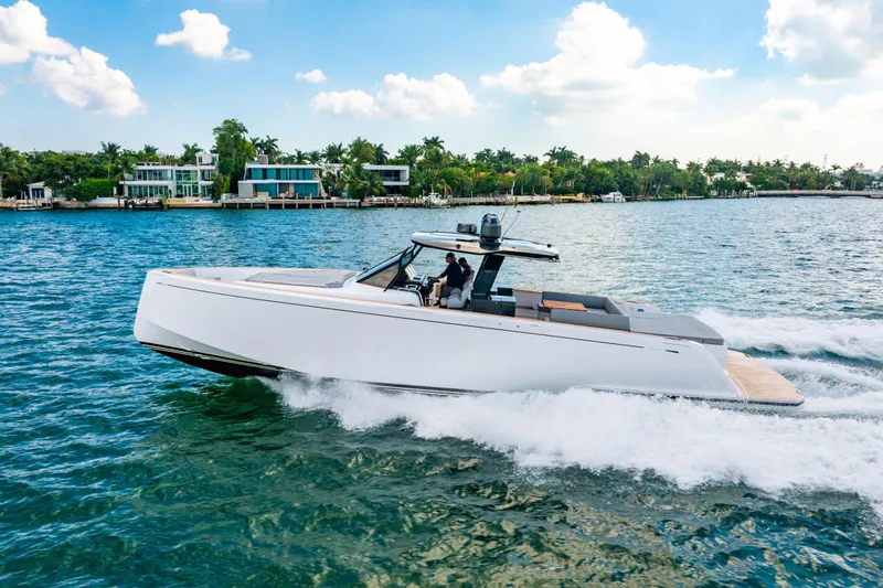 Slide: The Image of 2023 Pardo 50 yacht cruising on a sunny day near luxury waterfront homes. - 44