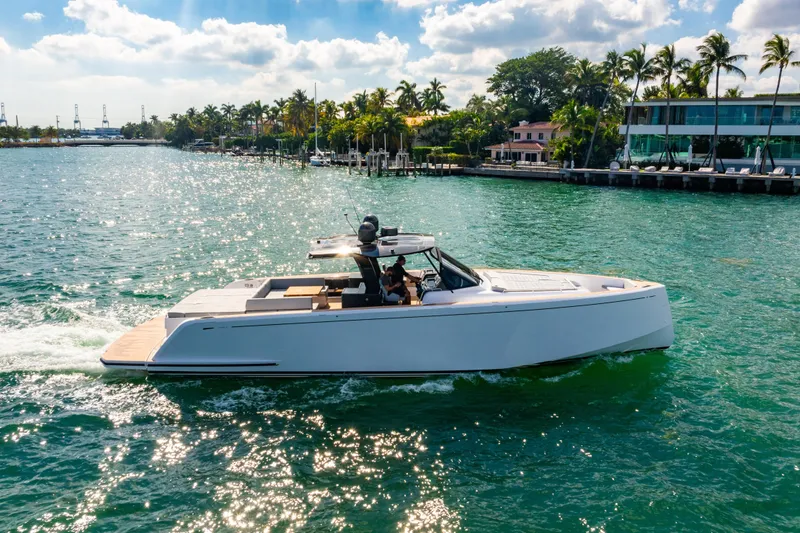 Slide: The Image of 2023 Pardo 50 yacht cruising on a sunny day near a tropical shoreline. - 5