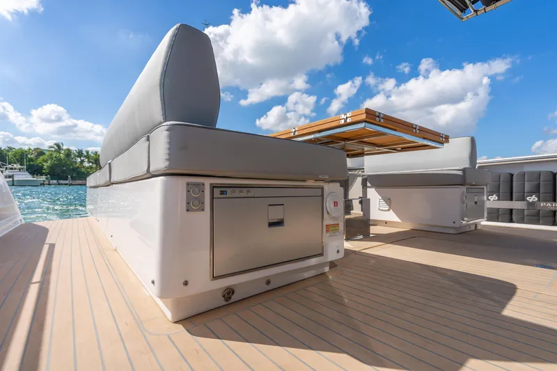 Slide: The Image of Luxurious 2023 Pardo 50 yacht deck with seating and storage, under a clear blue sky. - 56